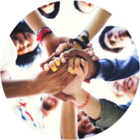 young people in a circle holding hands in the center